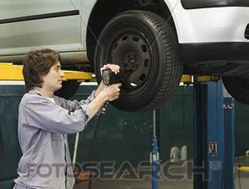 mechanic-changing-tires-of-car-elevated-stock-photo__paa570000064